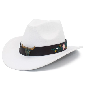 Detail of western cattle skull buckle and floral embroidery on white felt cowboy hat