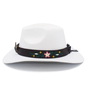 Detail of the white felt western cowboy hat with floral embroidery and brown leather band
