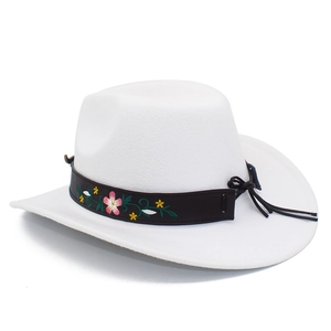 Detail of white felt cowboy hat featuring colorful floral embroidery on a black leather band