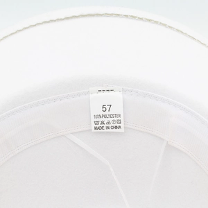 Detail shot of the white felt cowboy hat interior with a size 57 label and sweatband