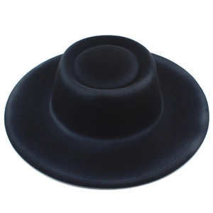 Top view of black wool felt boater hat with a flat crown and textured finish