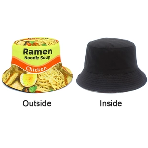 Detailed view of reversible bucket hat showing ramen print and plain black lining side