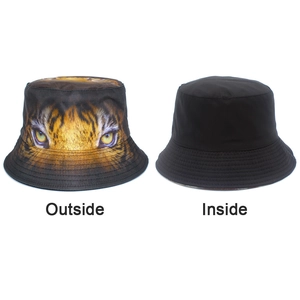 Dual-sided bucket hat detail showing a fierce tiger eyes print and a plain black inside