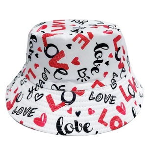 Dettaglio cappello a secchiello bianco con scritte LOVE rosse e nere e motivi a cuore