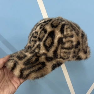 Close-up of leopard print faux fur texture and stitching on this warm baseball cap