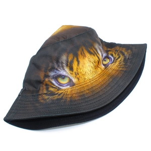 Detailed view of bucket hat featuring realistic tiger eye digital print and parallel stitching