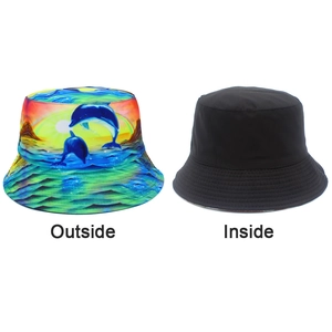 Detail of reversible bucket hat showing vivid dolphin print and minimalist black inner side