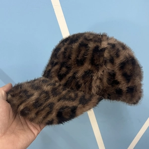 Detail shot of leopard print faux fur baseball cap showing soft plush texture and pattern
