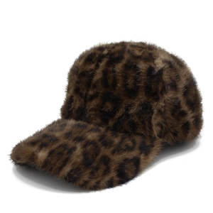 Close-up of plush faux fur texture on a warm leopard print baseball cap for winter