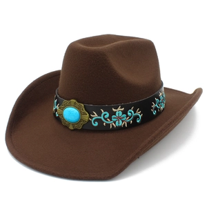 Detailed view of brown felt cowboy hat with ethnic embroidery and turquoise stone