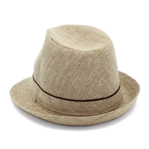 Close-up of beige woven straw fabric texture and brown decorative band on fedora hat