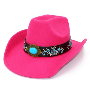Detail of fuchsia wool cowboy hat featuring vintage turquoise stone and floral embroidery