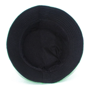 Detail view of the black cotton lining and reinforced stitching of the green bucket hat
