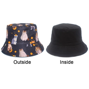 Dual-sided bucket hat featuring vibrant cat patterns and a solid black inner side