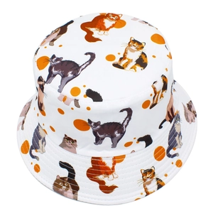 White bucket hat featuring cute all-over cat prints and orange polka dots for sun protection