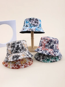 Detail showing various colors of leaf print bucket hats for sun protection