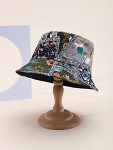 Detail of floral paisley patchwork bucket hat with olive green cotton and stitched brim