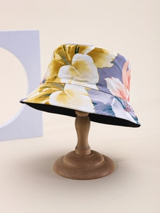 Detailed close-up of floral canvas bucket hat on a wooden stand with clear fabric texture