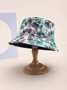 Detail of leaf print bucket hat showing fabric texture and green foliage pattern