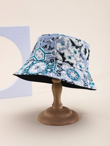 Close-up of printed bucket hat featuring blue geometric and abstract floral patterns