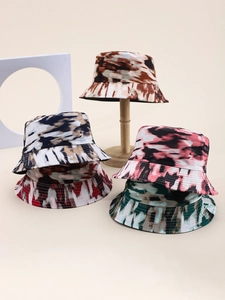Detailed view of canvas bucket hats featuring diverse abstract tie-dye print patterns