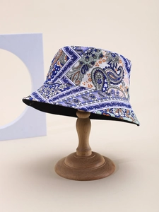 Detail of bohemian paisley bucket hat showing purple pattern and black reversible interior