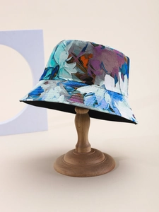 Detail shot of the abstract floral pattern on a cotton bucket hat with blue and orange tones