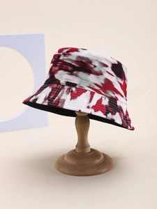Close-up detail of the splash ink tie-dye pattern on the wide brim of a cotton bucket hat