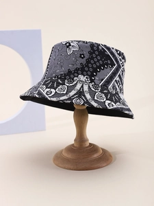Detailed macro view of paisley floral pattern on a canvas bucket hat with firm stitching