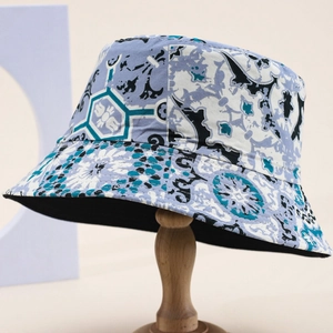 Unisex bucket hat with blue and gray geometric pattern on a wooden display stand