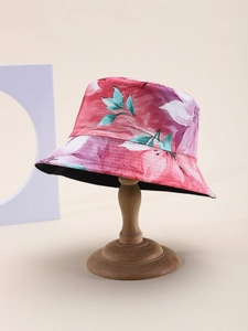 Detailed close-up of a floral bucket hat featuring pink and purple flower prints on a stand