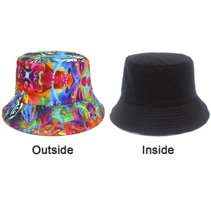 Detail of reversible bucket hat showing colorful street graffiti print and solid black side