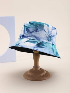 Close-up of blue floral sun hat on a wooden stand with detailed stitching and soft lining