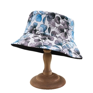 Fashionable sun hat with blue and grey leaf print on white cotton fabric for outdoor wear