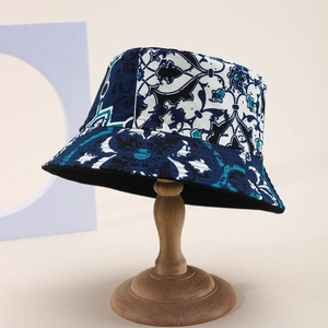 Close-up of vintage totem print cotton bucket hat with wide brim on wooden stand