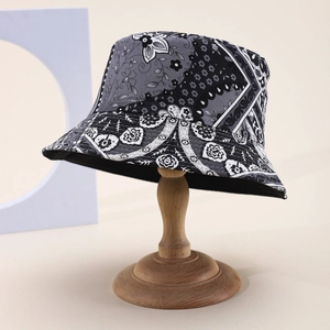 Fashionable floral patchwork bucket hat with paisley pattern on wooden display stand