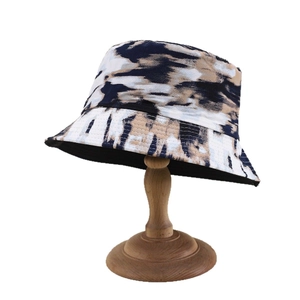 Reversible tie-dye bucket hat in navy and khaki, foldable outdoor cotton sun protection cap