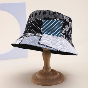 Vintage floral patchwork bucket hat with dots and stripes pattern on a wooden stand