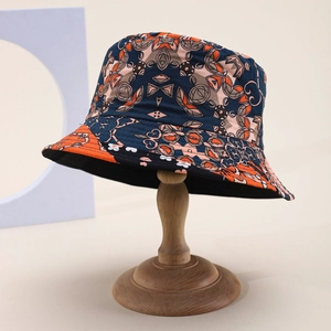 Reversible bucket hat with vintage geometric pattern on a stylish wooden stand