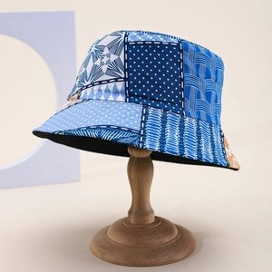 Detail of patchwork bucket hat featuring blue denim patterns and premium black lining