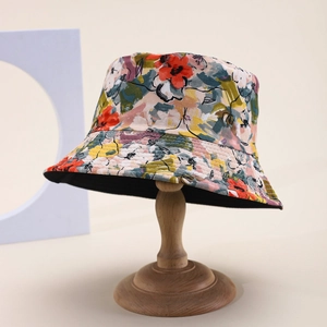 Detailed view of floral bucket hat with colorful patterns and reinforced stitching