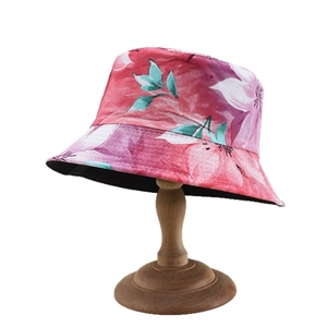 Floral print bucket hat for women with pink and purple flower patterns on a vintage stand