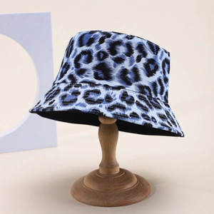 Blue leopard print bucket hat on vintage wood stand with stylish flat top and wide brim