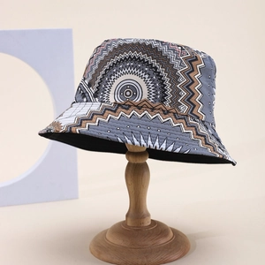 Detail view of cotton bucket hat with ethnic mandala pattern on vintage wooden stand
