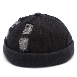 Distressed black denim miki hat featuring vintage rip details and brimless design