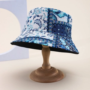 Detailed view of bucket hat with blue paisley and geometric floral patchwork design