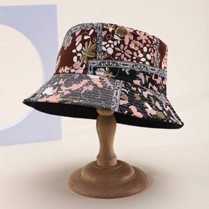 Close-up of the bucket hat featuring floral patchwork and premium canvas texture