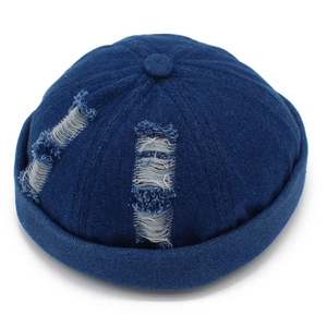 Detail of distressed navy denim miki hat showing washed texture and frayed hole accents