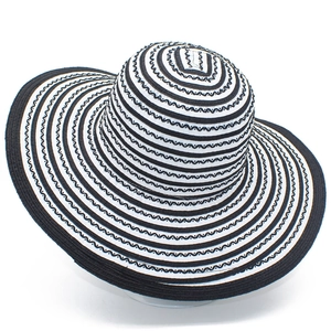 Women's wide brim black and white striped straw sun hat with wavy pattern on white background