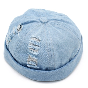 Macro shot of light blue denim miki hat showing distressed holes and twill fabric texture